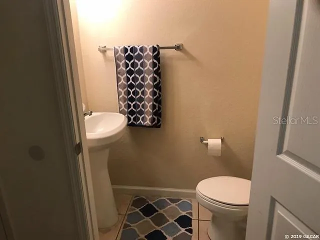 a white toilet sitting next to a shower curtain