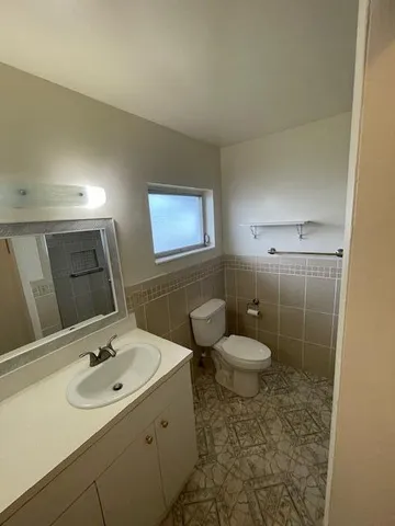 a bathroom with a shower a toilet and sink