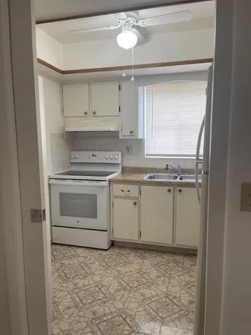 a room with a stove and a sink