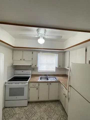 a kitchen with a stove a sink and a refrigerator