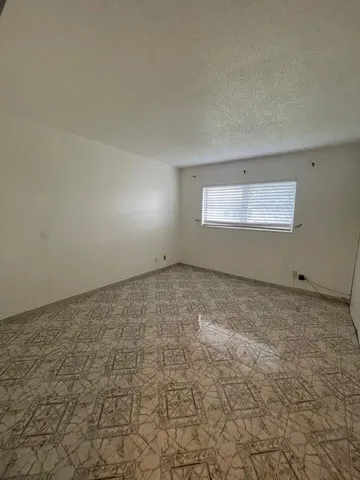 an empty room with a empty space and window