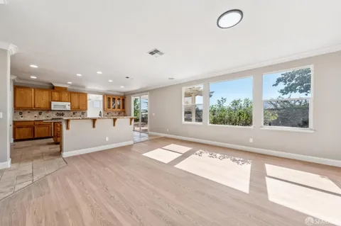 an empty room with windows and chandelier