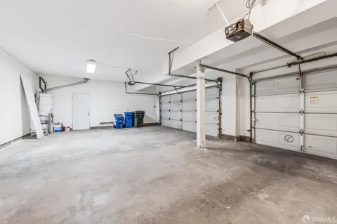 a spacious bathroom with a granite countertop sink and a mirror