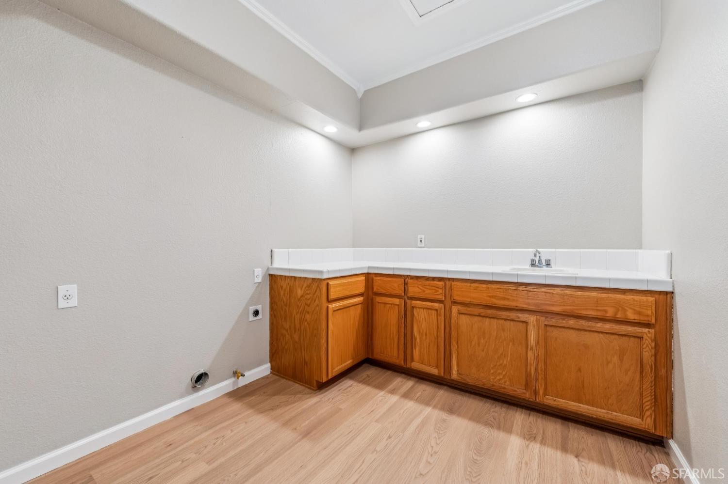 2344 Forty Niner Court Antioch, CA 94531 - Photo 44 of 94 a view of an empty room with wooden floor and cabinet