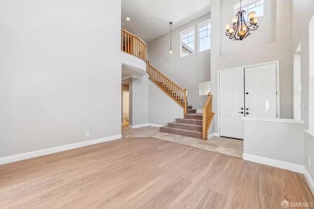 a view of a livingroom with wooden floor and a ceiling fan