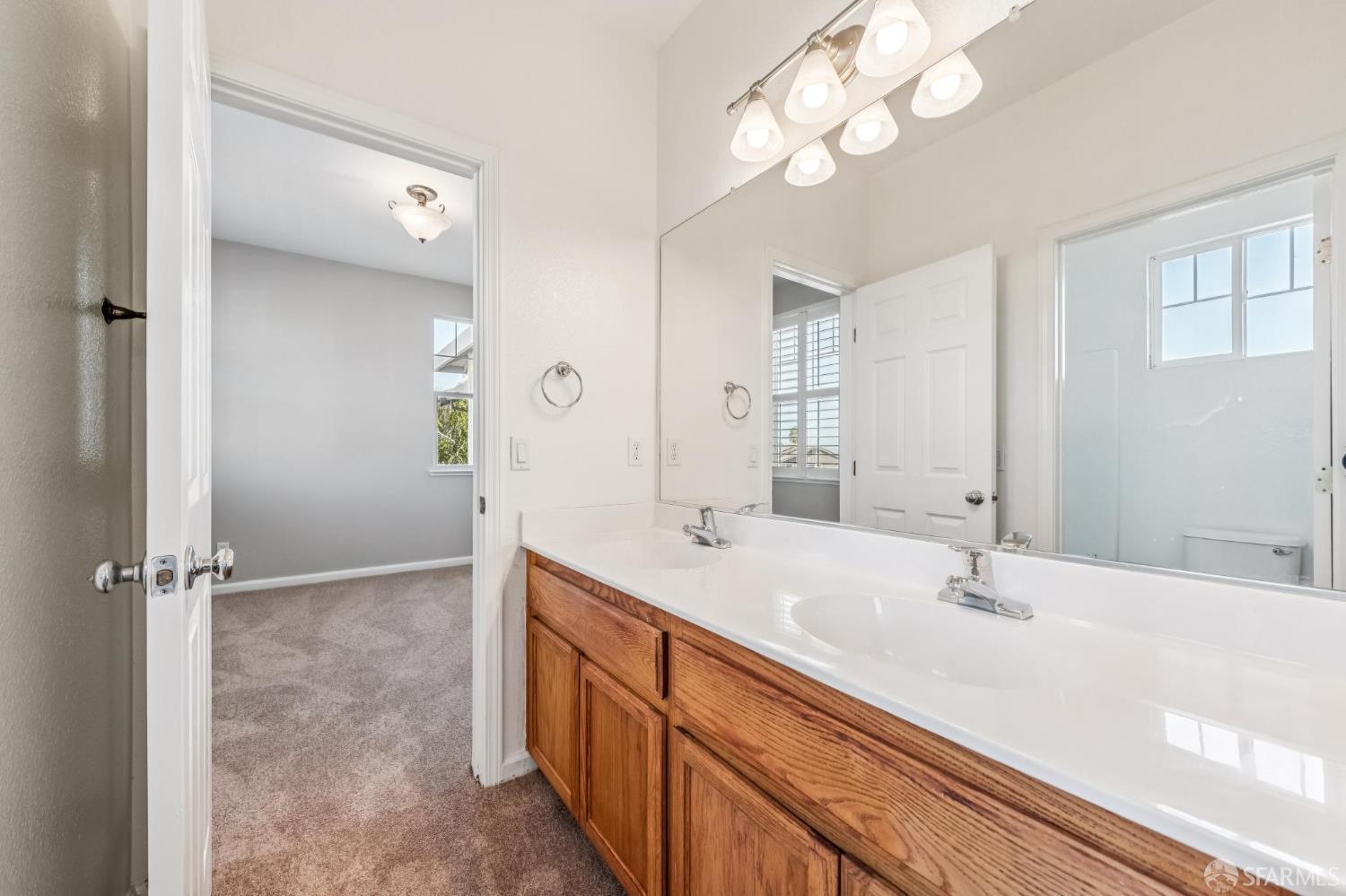 2344 Forty Niner Court Antioch, CA 94531 - Photo 71 of 94 a bathroom with a sink a light fixture and a mirror
