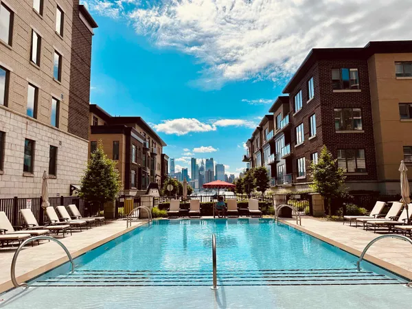 a view of a swimming pool with outdoor seating