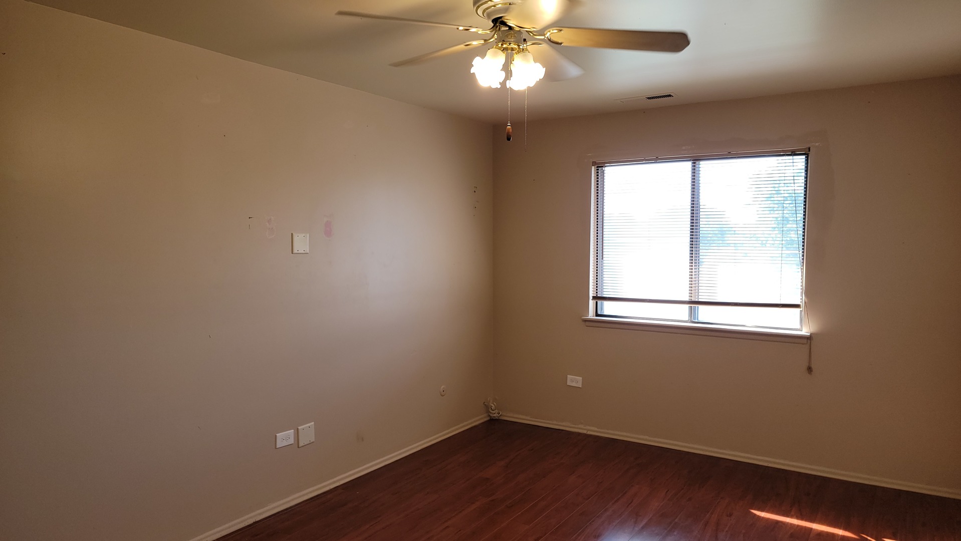 14621 Greenwood Road, Unit 408 Dolton, IL 60419 - Photo 11 of 25 a view of an empty room with wooden floor and a window