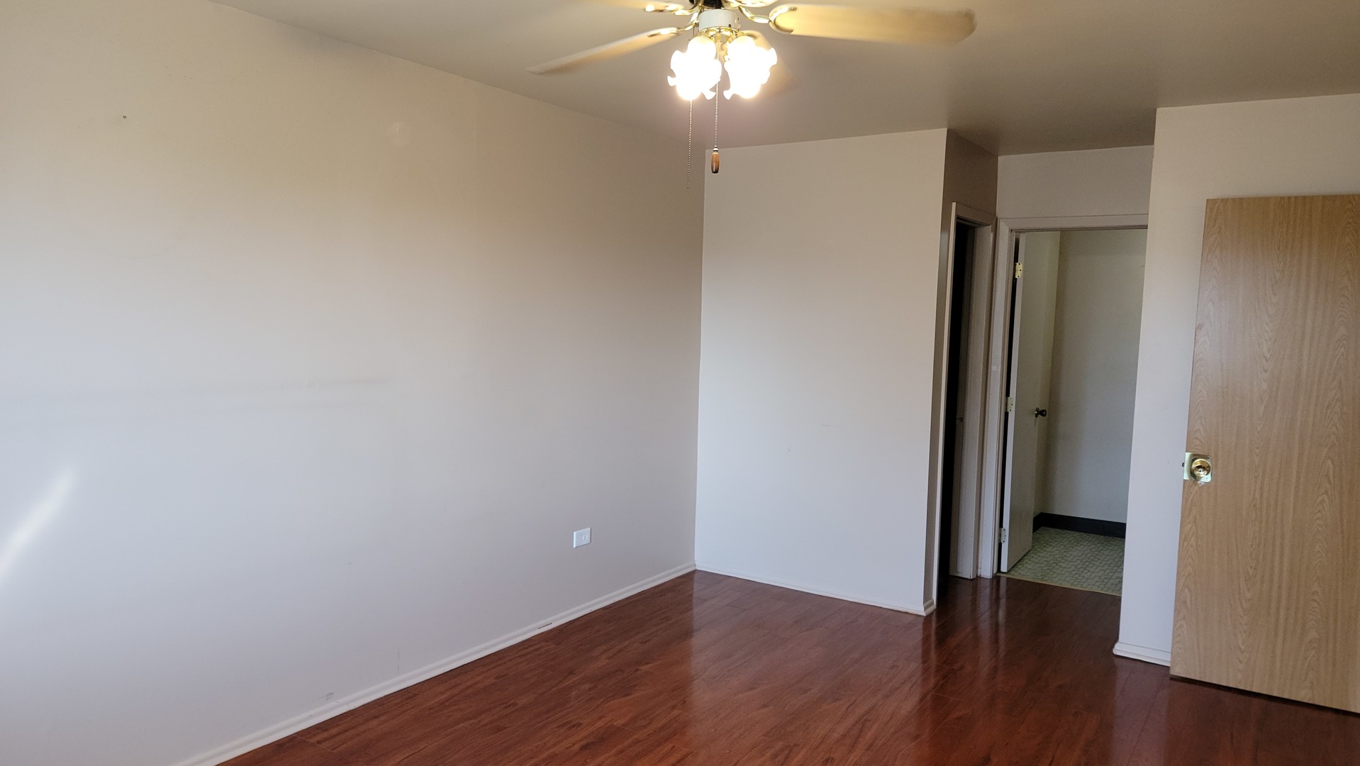 14621 Greenwood Road, Unit 408 Dolton, IL 60419 - Photo 12 of 25 a view of an empty room with wooden floor and a window