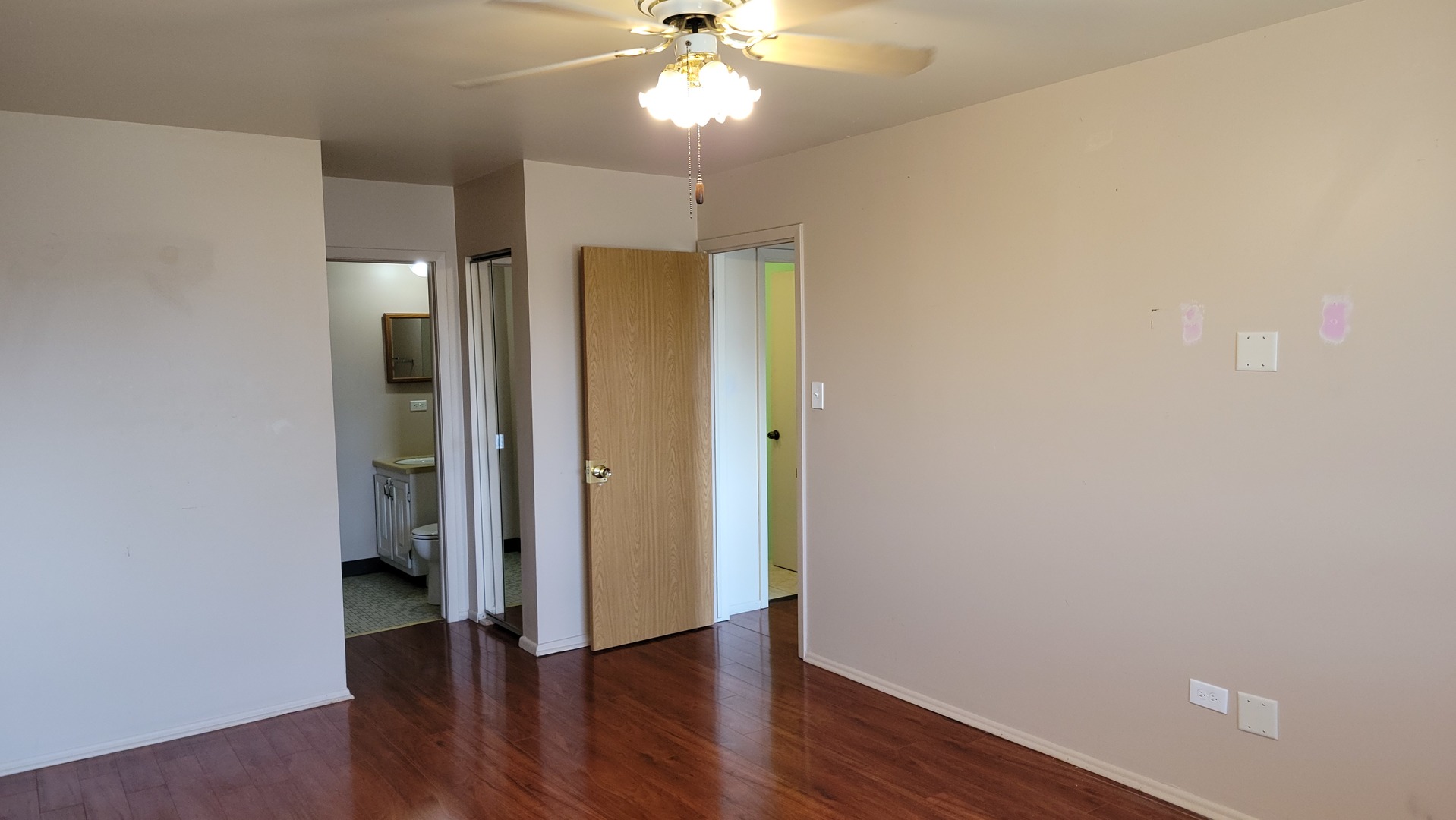 14621 Greenwood Road, Unit 408 Dolton, IL 60419 - Photo 13 of 25 an empty room with wooden floor and a ceiling fan