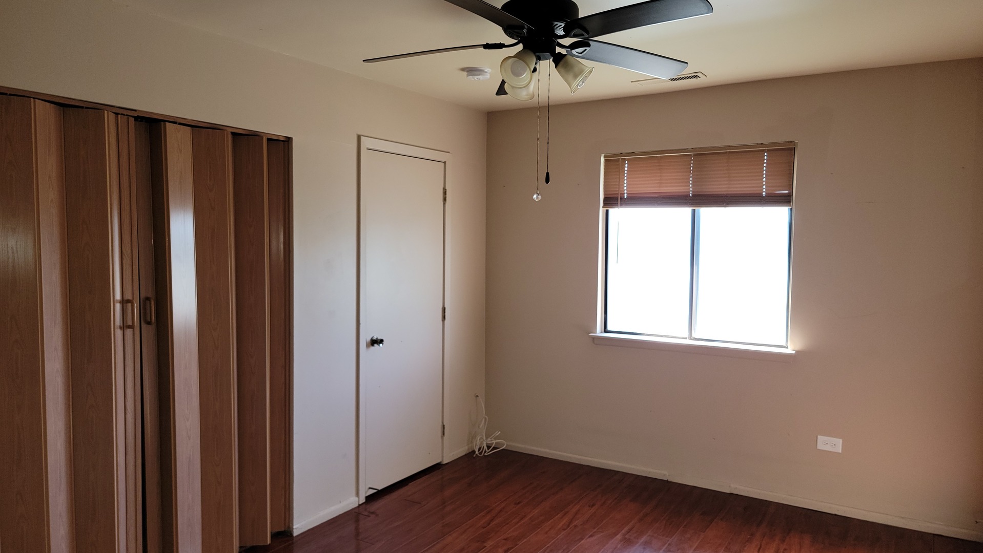 14621 Greenwood Road, Unit 408 Dolton, IL 60419 - Photo 17 of 25 a view of an empty room with wooden floor and a window