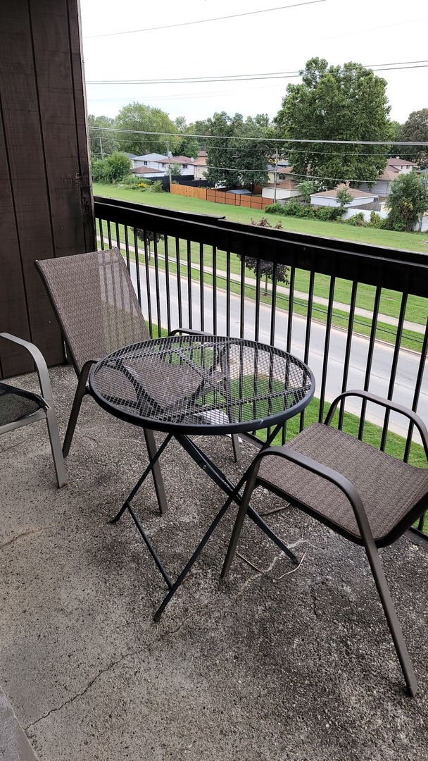 14621 Greenwood Road, Unit 408 Dolton, IL 60419 - Photo 19 of 25 a view of a two chairs and table in the balcony