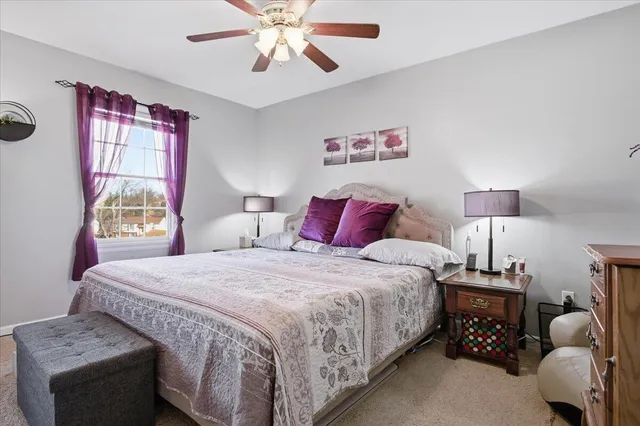 a bedroom with a bed and a flat tv screen on the dresser