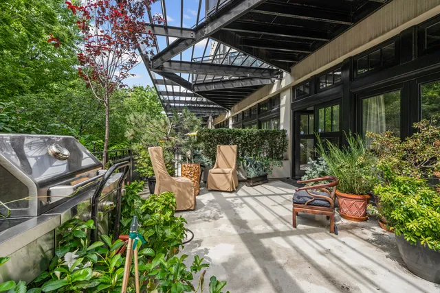 a view of a porch with furniture and garden