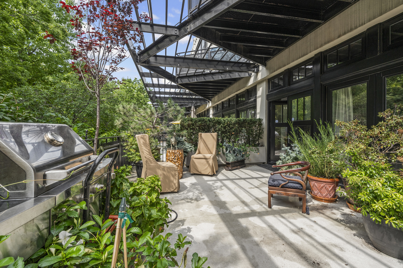 a view of a porch with furniture and garden