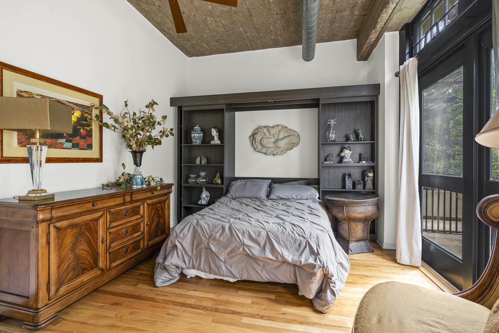 1070 West 15th Street, Unit 147 Chicago, IL 60608 - Photo 11 of 17 a bedroom with a bed and dresser with mirror