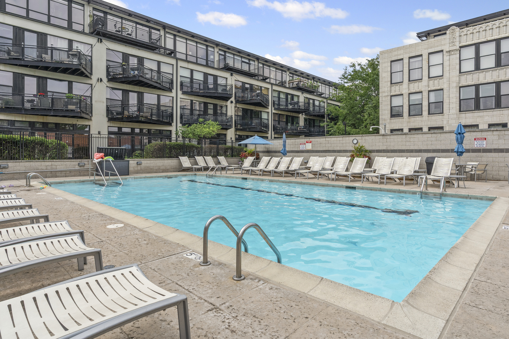 1070 West 15th Street, Unit 147 Chicago, IL 60608 - Photo 15 of 17 a swimming pool with outdoor seating and yard