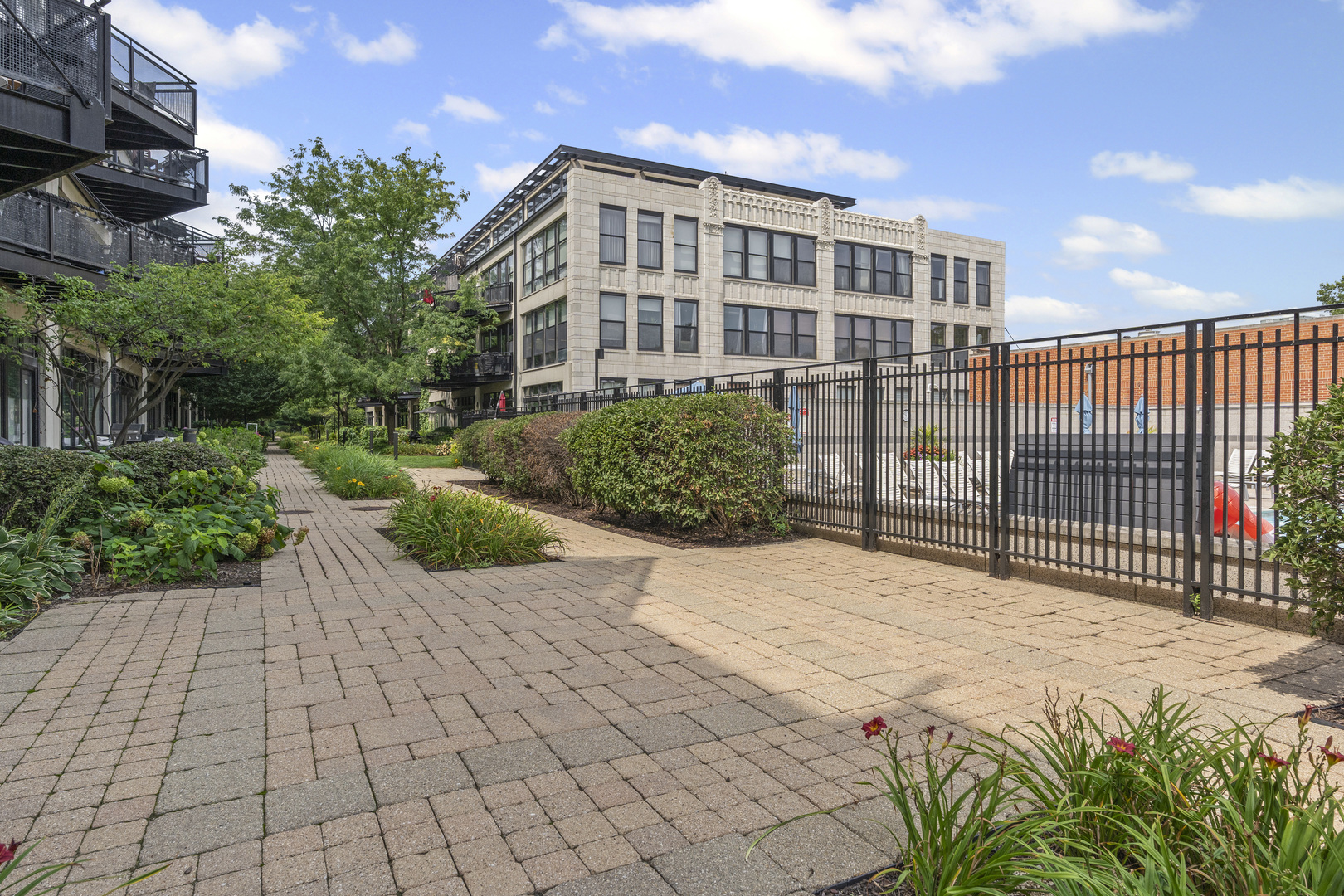 1070 West 15th Street, Unit 147 Chicago, IL 60608 - Photo 16 of 17 a view of a brick house with a yard
