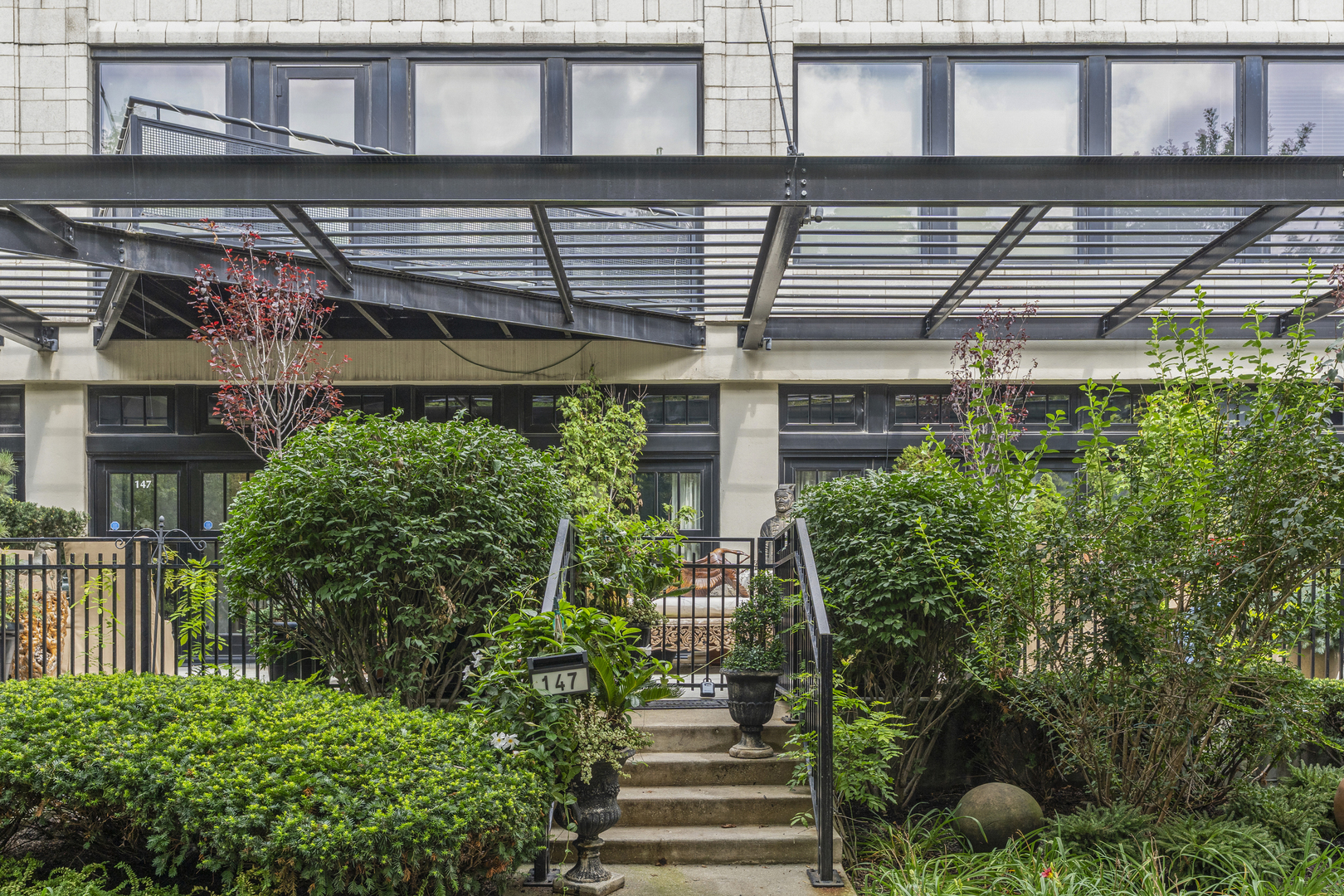 1070 West 15th Street, Unit 147 Chicago, IL 60608 - Photo 17 of 17 a view of a house with a potted plant and floor to ceiling windows