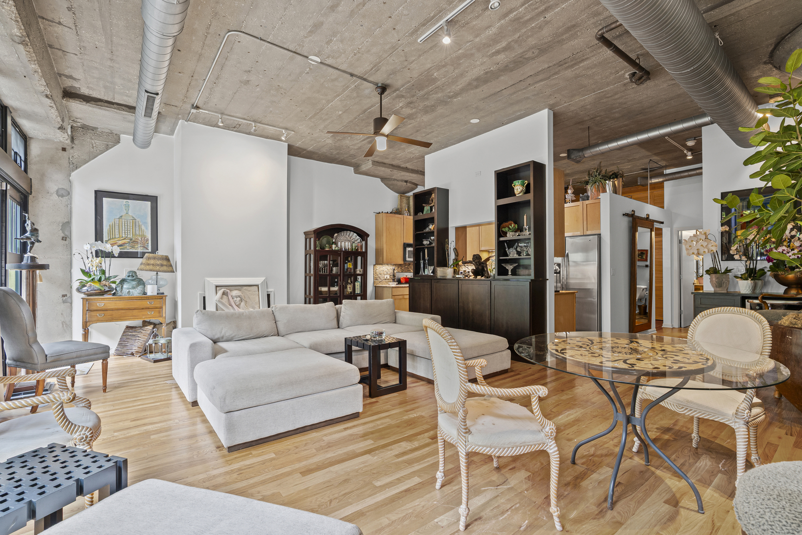 1070 West 15th Street, Unit 147 Chicago, IL 60608 - Photo 5 of 17 a living room with furniture and a chandelier