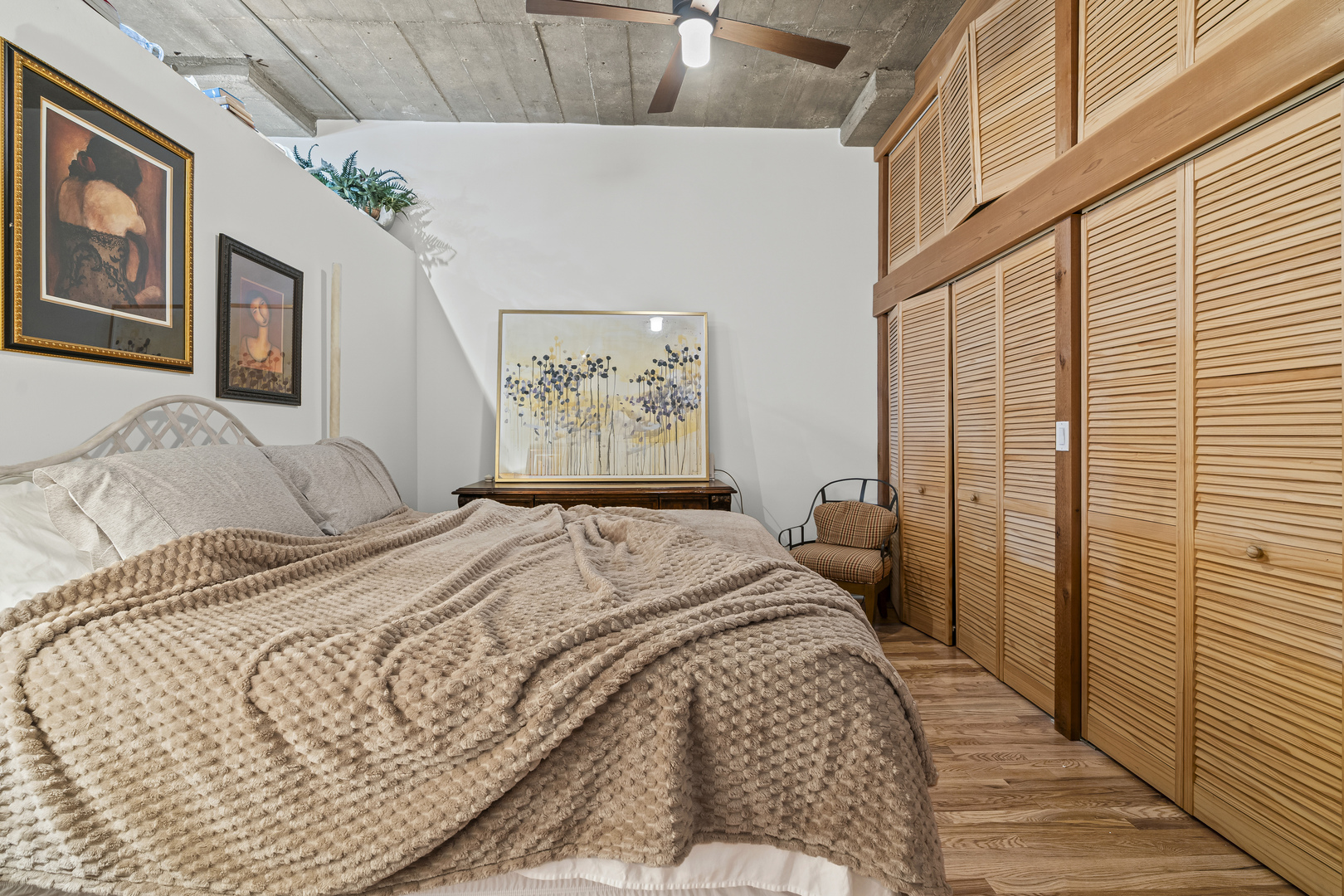 1070 West 15th Street, Unit 147 Chicago, IL 60608 - Photo 8 of 17 a bedroom with a bed painting on wall and a large window