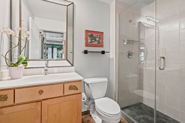 a bathroom with a sink a toilet and shower