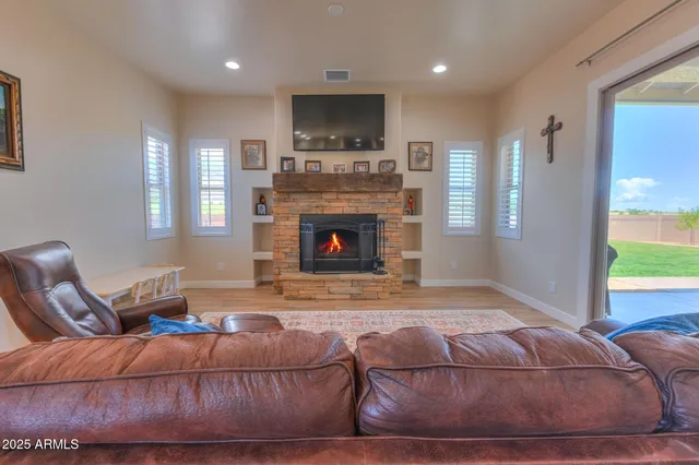 a living room with furniture and a fireplace