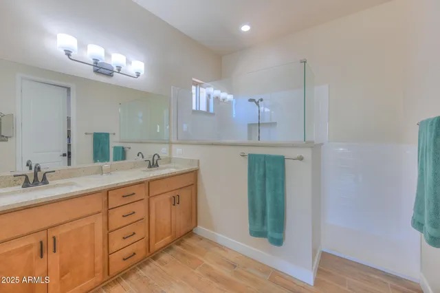 a bathroom with a double vanity sink and a mirror