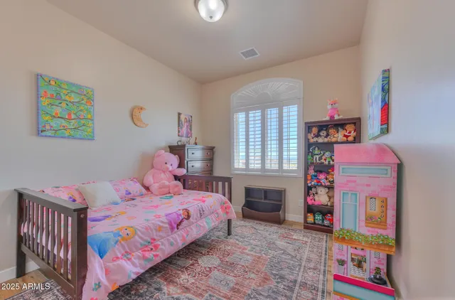 a bedroom with a bed and a dresser in it