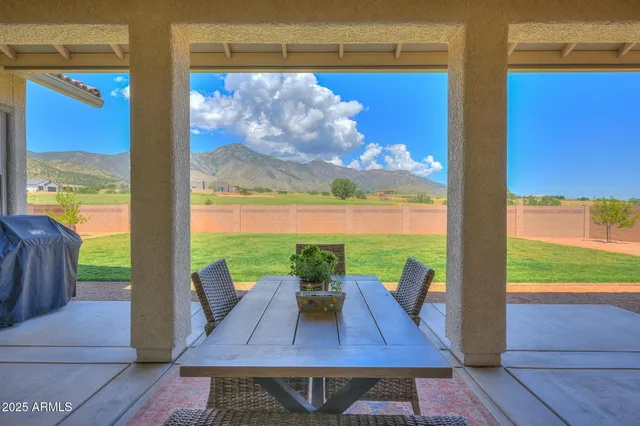 a view of a house with a big yard and large trees