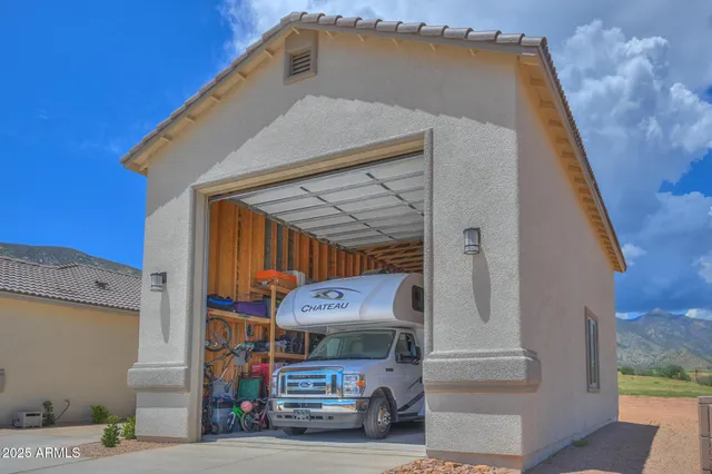 an aerial view of a house with a yard and lake view