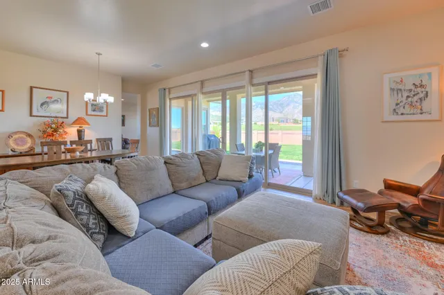 a living room with furniture a dining table and chairs with wooden floor