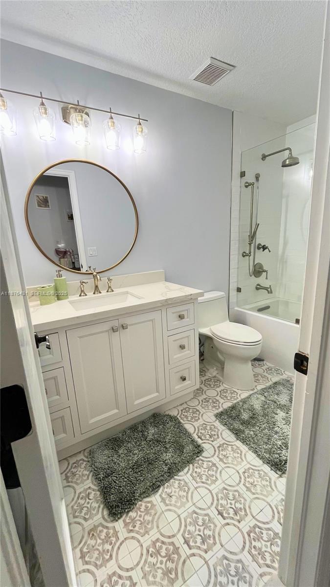 16605 Southwest 90th Street Miami, FL 33196 - Photo 13 of 35 a bathroom with a sink toilet mirror vanity and bathtub