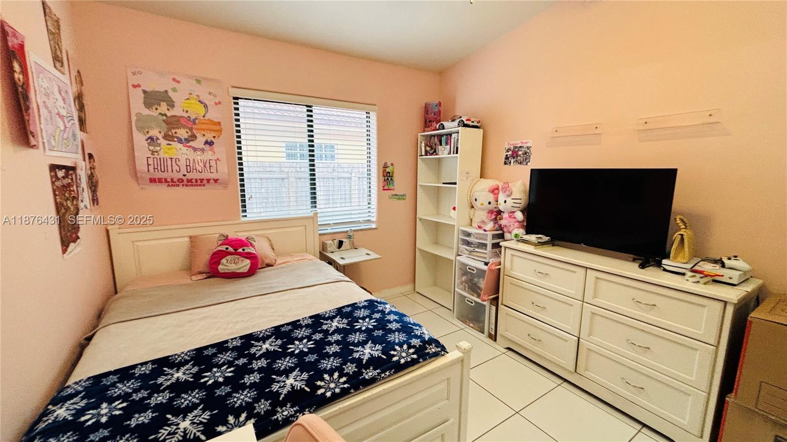 16605 Southwest 90th Street Miami, FL 33196 - Photo 19 of 35 a bedroom with a bed and a flat screen tv