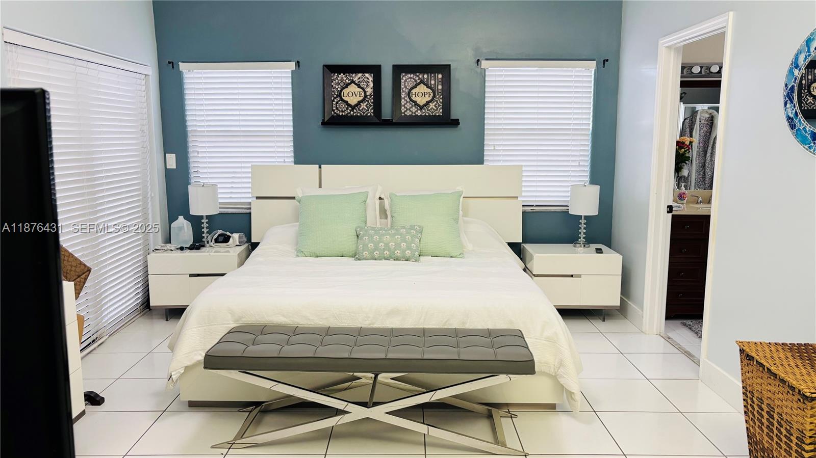 16605 Southwest 90th Street Miami, FL 33196 - Photo 20 of 35 a bedroom with a bed a rug and a large window