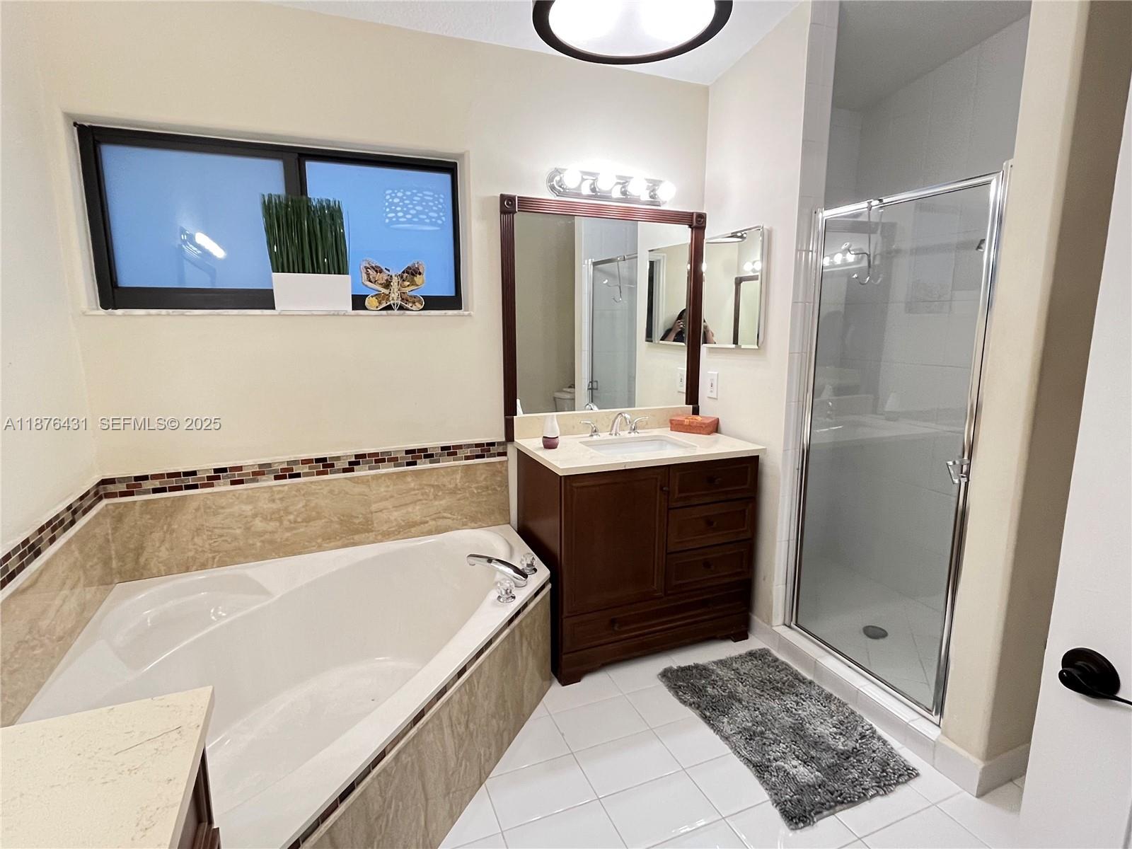 16605 Southwest 90th Street Miami, FL 33196 - Photo 26 of 35 a bathroom with a tub sink and mirror