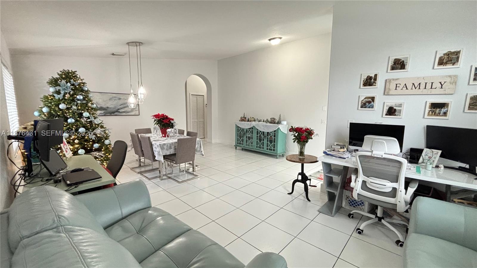 16605 Southwest 90th Street Miami, FL 33196 - Photo 3 of 35 a living room with furniture and a potted plant