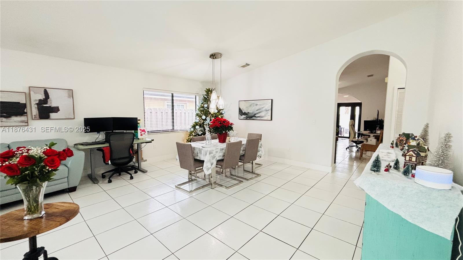 16605 Southwest 90th Street Miami, FL 33196 - Photo 5 of 35 a living room with furniture and a flat screen tv