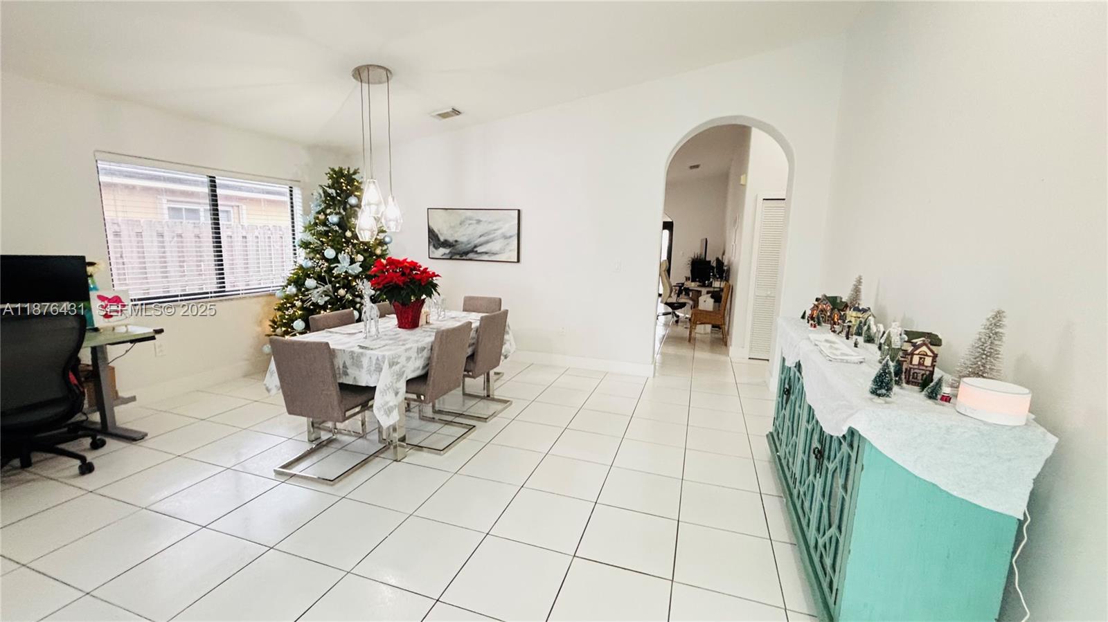 16605 Southwest 90th Street Miami, FL 33196 - Photo 6 of 35 a living room with furniture a dining table and a potted plant
