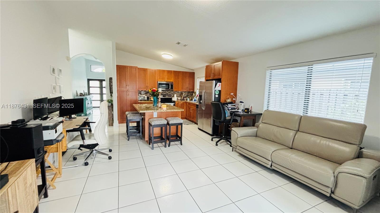 16605 Southwest 90th Street Miami, FL 33196 - Photo 10 of 35 a living room with furniture a flat screen tv and a window