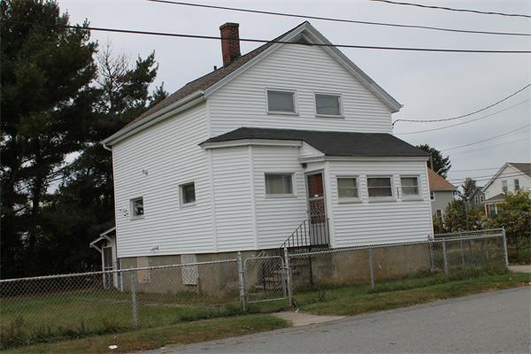 121 Garfield Street Fall River, MA 02721 - Photo 1 of 3 a front view of a house with a yard