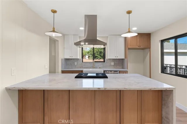 a kitchen with stainless steel appliances a counter tops and a wooden floors