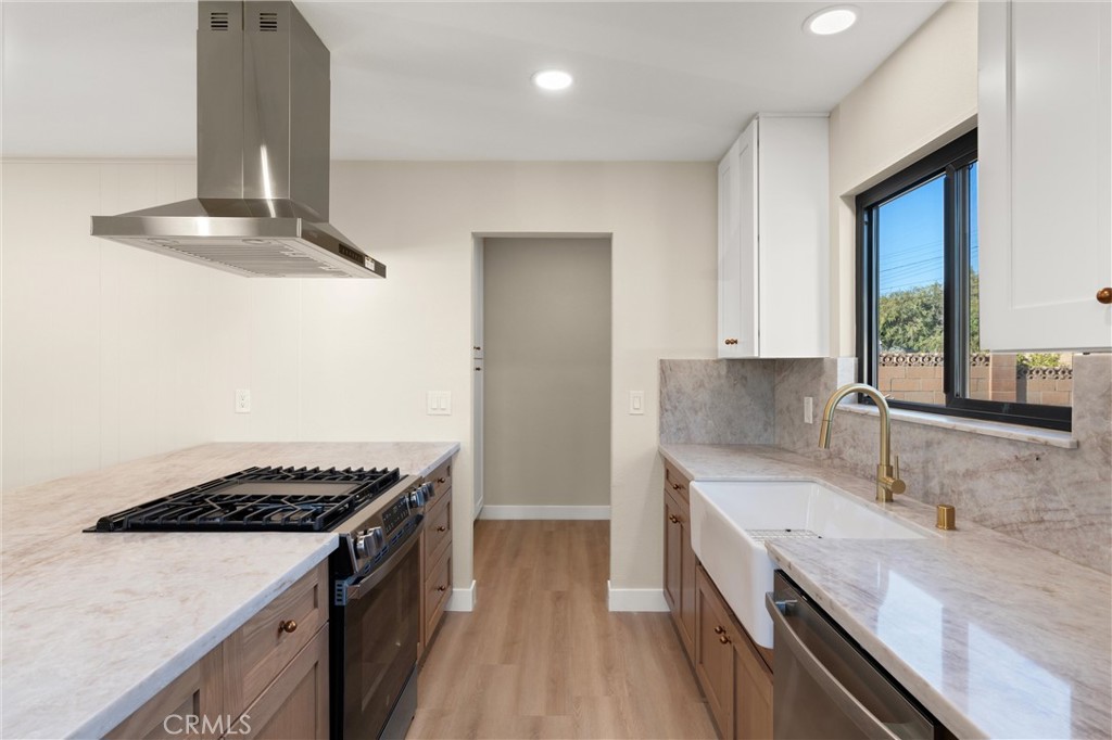13562 Springdale Street Westminster, CA 92683 - Photo 13 of 34 a kitchen with granite countertop stainless steel appliances sink stove and cabinets