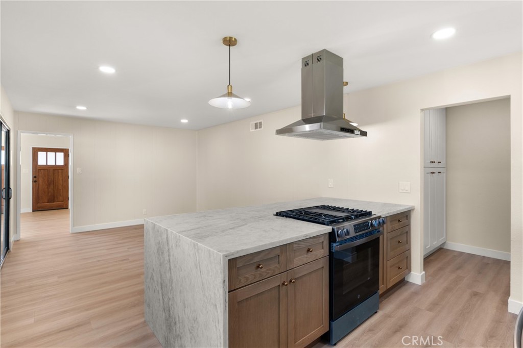 13562 Springdale Street Westminster, CA 92683 - Photo 14 of 34 a kitchen with a stove and a wooden floor