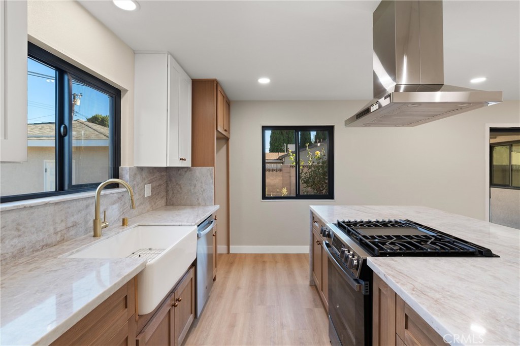 13562 Springdale Street Westminster, CA 92683 - Photo 15 of 34 a kitchen with a sink stove and cabinets