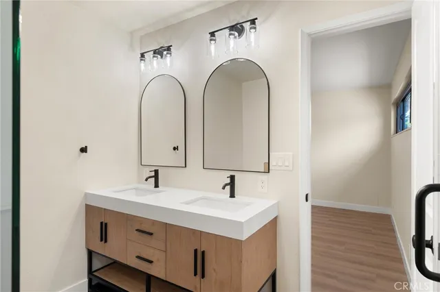 a bathroom with a double vanity sink and a mirror