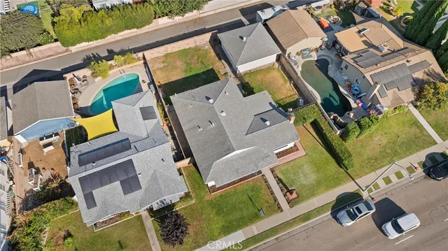 an aerial view of a house with a yard