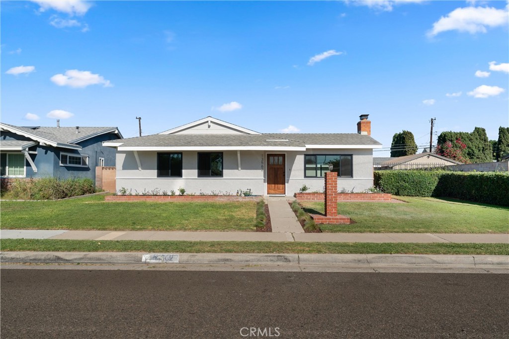 13562 Springdale Street Westminster, CA 92683 - Photo 4 of 34 a front view of a house with a garden