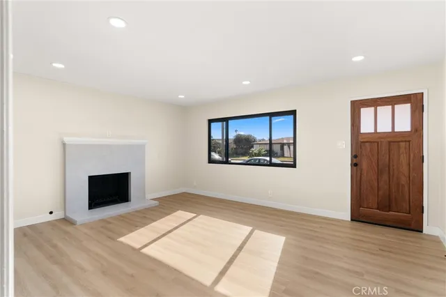 a view of an empty room with glass door and a window