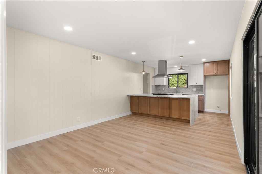 13562 Springdale Street Westminster, CA 92683 - Photo 9 of 34 a view of kitchen with kitchen island microwave and wooden floor